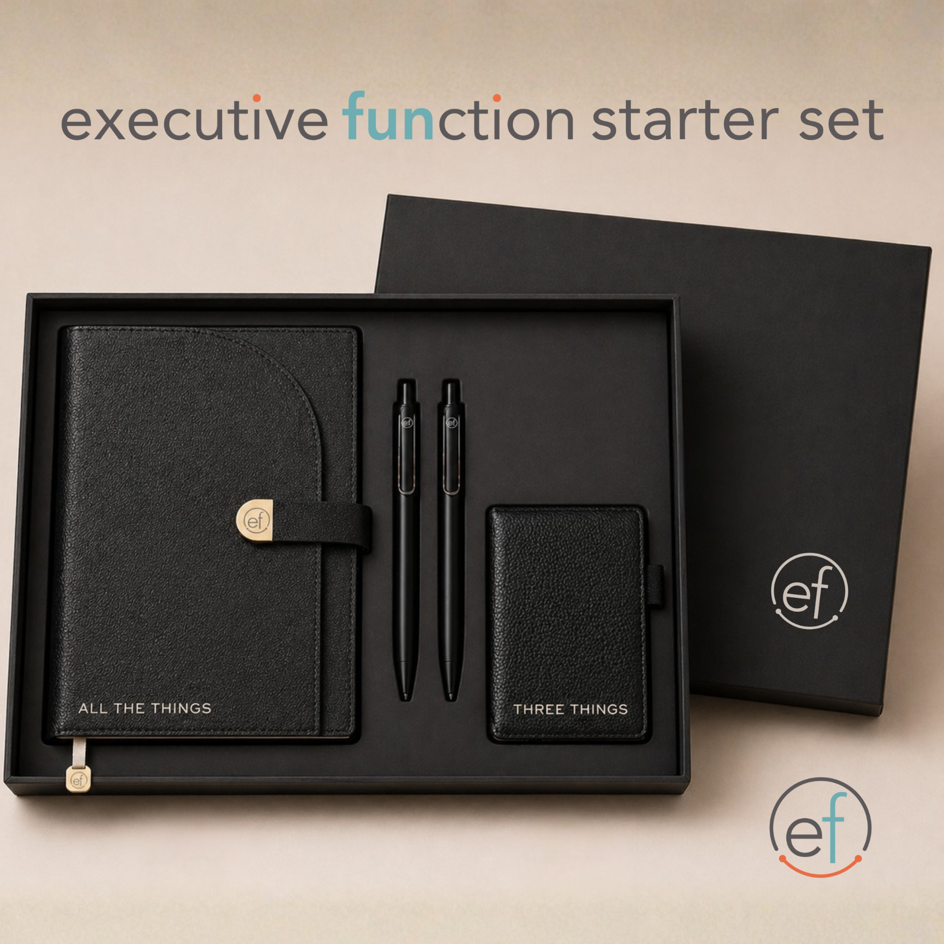 The Executive FUNction kit laid out in a black presentation box: All the Things journal, Keep It Together pouch, Start/Move/Reset roller bottles, Pick 3 notepad, wooden decision die, grounding anchor card, and wooden kitchen timer on shredded kraft filler